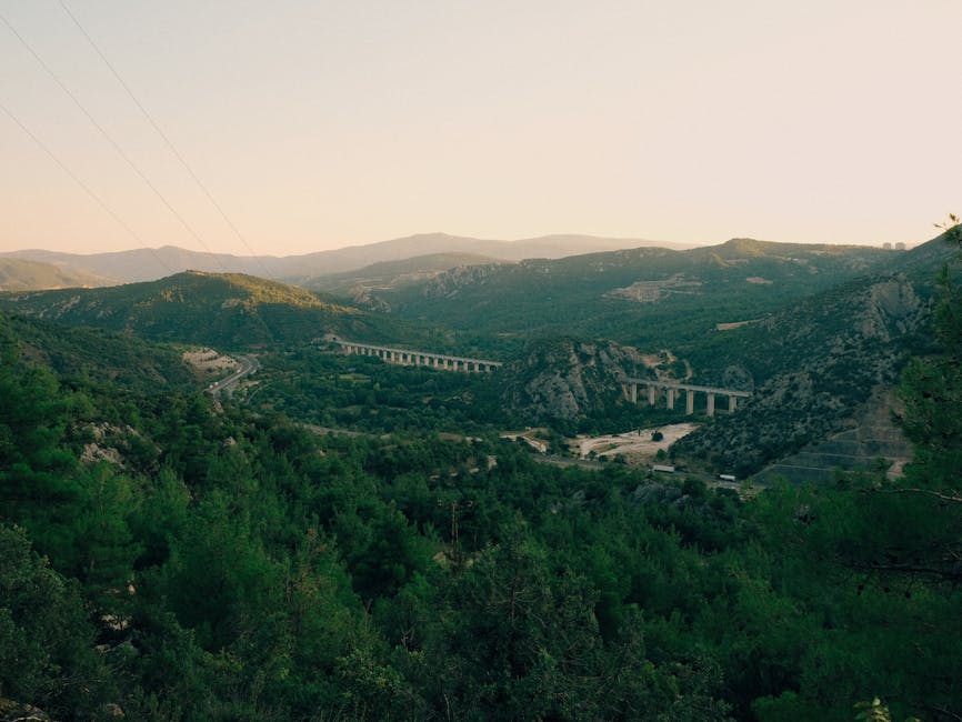 Scenic landscape of Bilecik's lush green mountains and bridge at sunset.